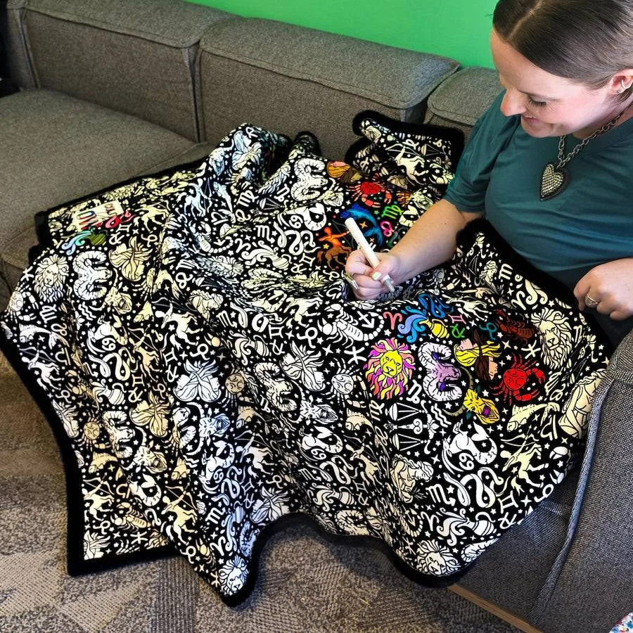 Coloring in a Coloring Your Own blanket on the couch