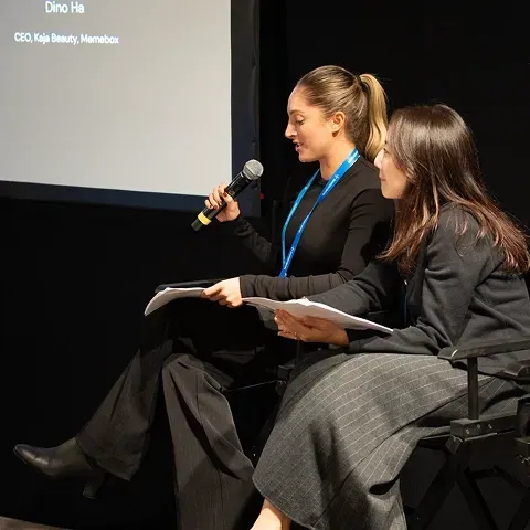 Two speakers seated on stage for a keynote Q&A at IPx LA