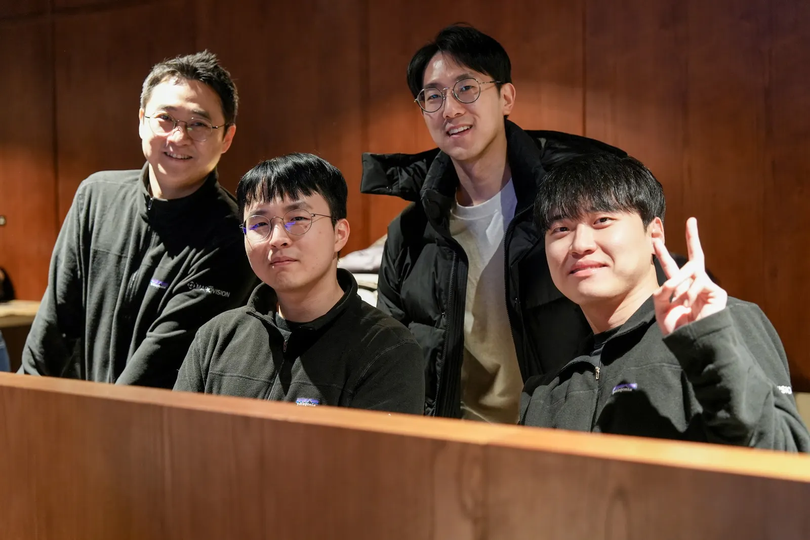 Four teammates smiling at a table